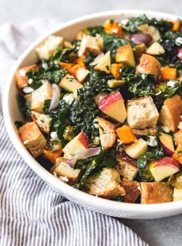 a white bowl filled with Fall Panzanella Salad