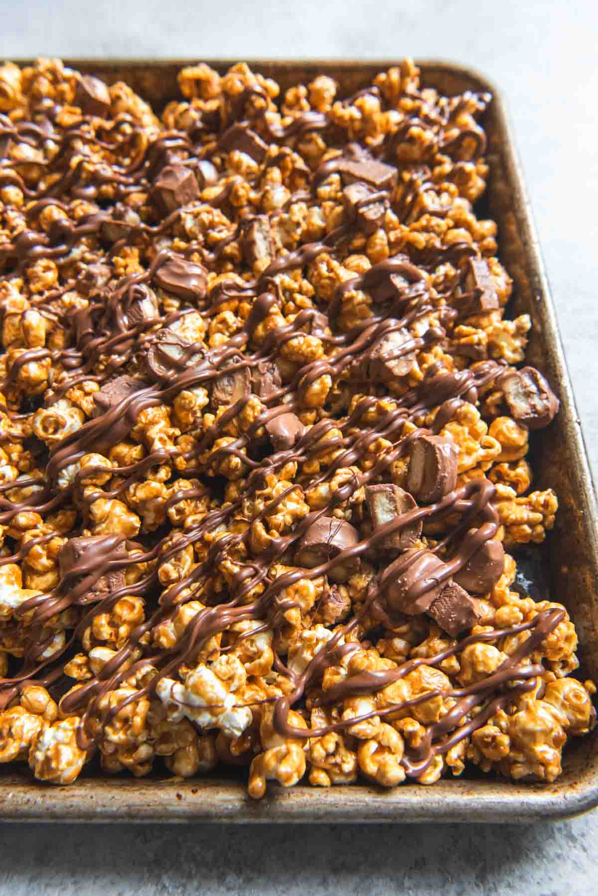 A baking sheet filled with Twix caramel popcorn.