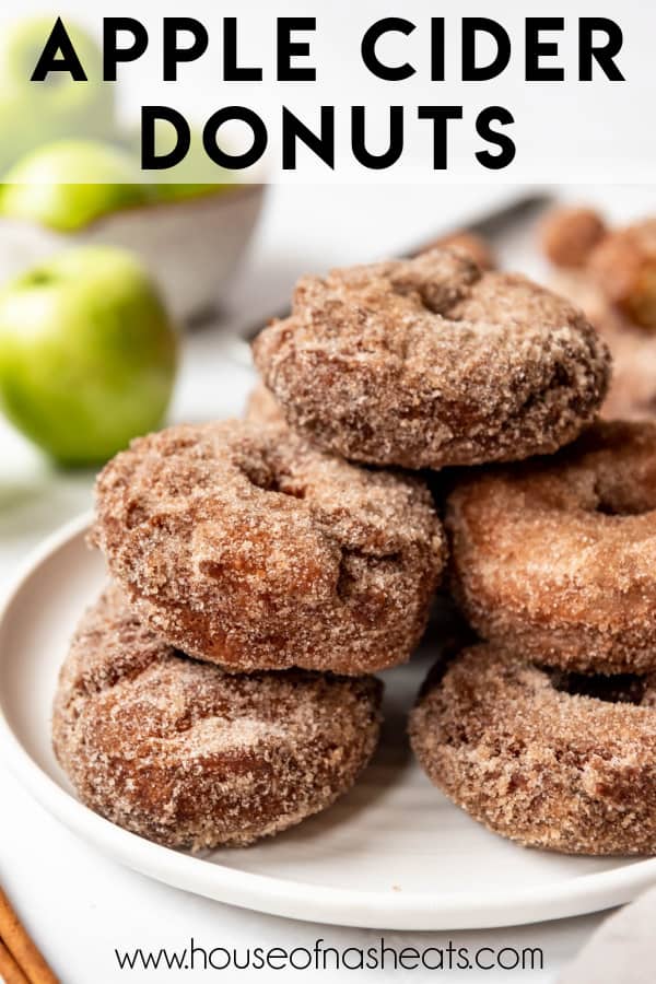 Stacked apple cider donuts on a plate with text overlay.