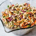 Asian Slaw with Ginger Peanut Dressing in a large glass measuring bowl