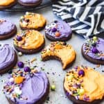 purple and orange frosted chocolate sugar cookies topped with sprinkles