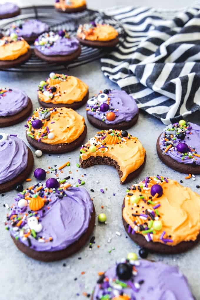 purple and orange frosted chocolate sugar cookies topped with sprinkles