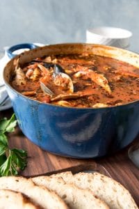 a large blue pot full of cioppino stew