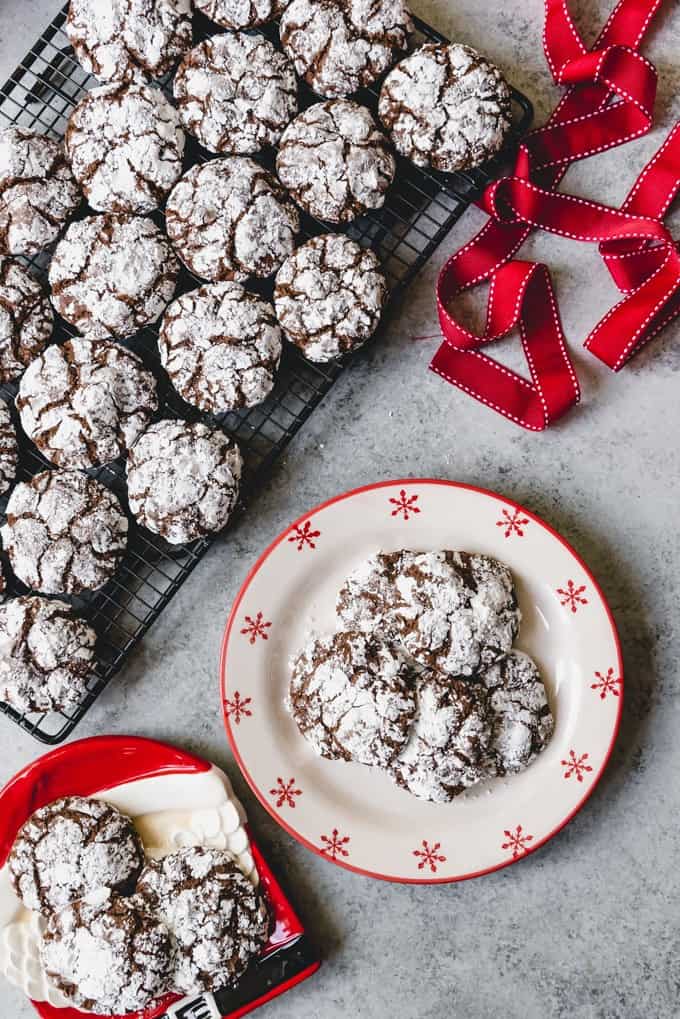 An image of a plate of chocolate Christmas cookies generously covered in powdered sugar.