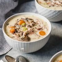 white bowls filled with creamy leftover turkey wildrice soup