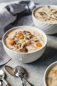 white bowls filled with creamy leftover turkey wildrice soup