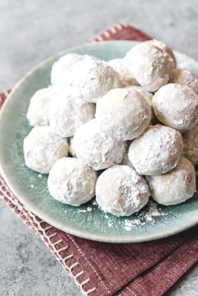 a plate of powdered sugar covered cookies