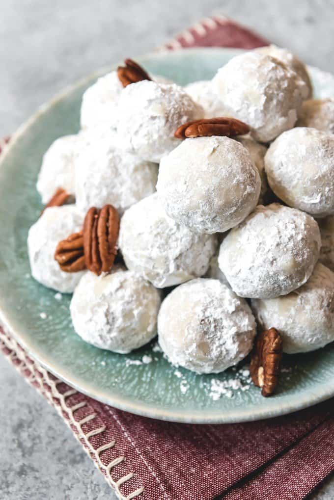 An image of a plate of Russian tea cakes, also known as Mexican wedding cookies, with pecans.