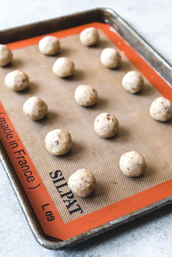 An image of Mexican Wedding Cookie dough rolled into balls and spaced on a baking sheet.