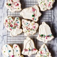 These Oatmeal Rolled Sugar Cookies are an old-fashioned cut-out sugar cookie recipe with a chewy twist thanks to the addition of rolled oats and almond extract.  We love them frosted with buttercream frosting and topped with colorful sprinkles!