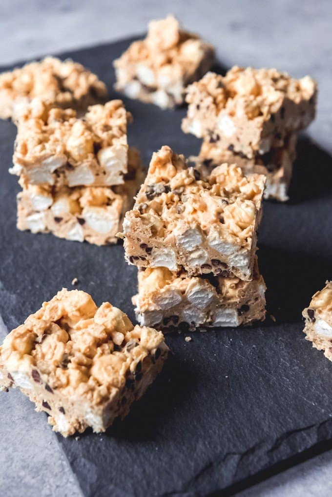 An image of peanut butter and white chocolate rice krispie treat bars with extra marshmallows and mini chocolate chips.