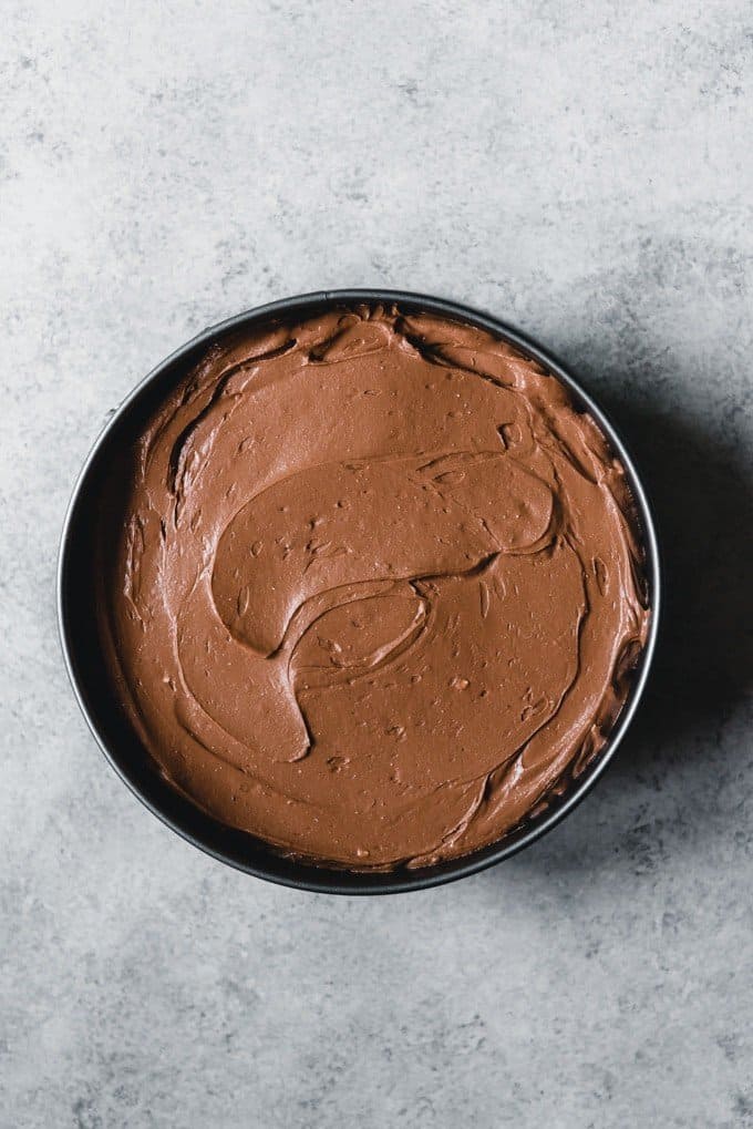 An image of an unbaked chocolate cheesecake in a 9-inch springform pan.