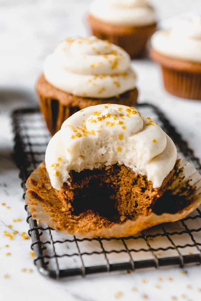 These moist Gingerbread Cupcakes with eggnog buttercream frosting are made from scratch and the perfect handheld non-cookie treat for your holiday party this year!  Made with molasses, ginger, cinnamon, and other spices, these cupcakes taste just like Christmas.