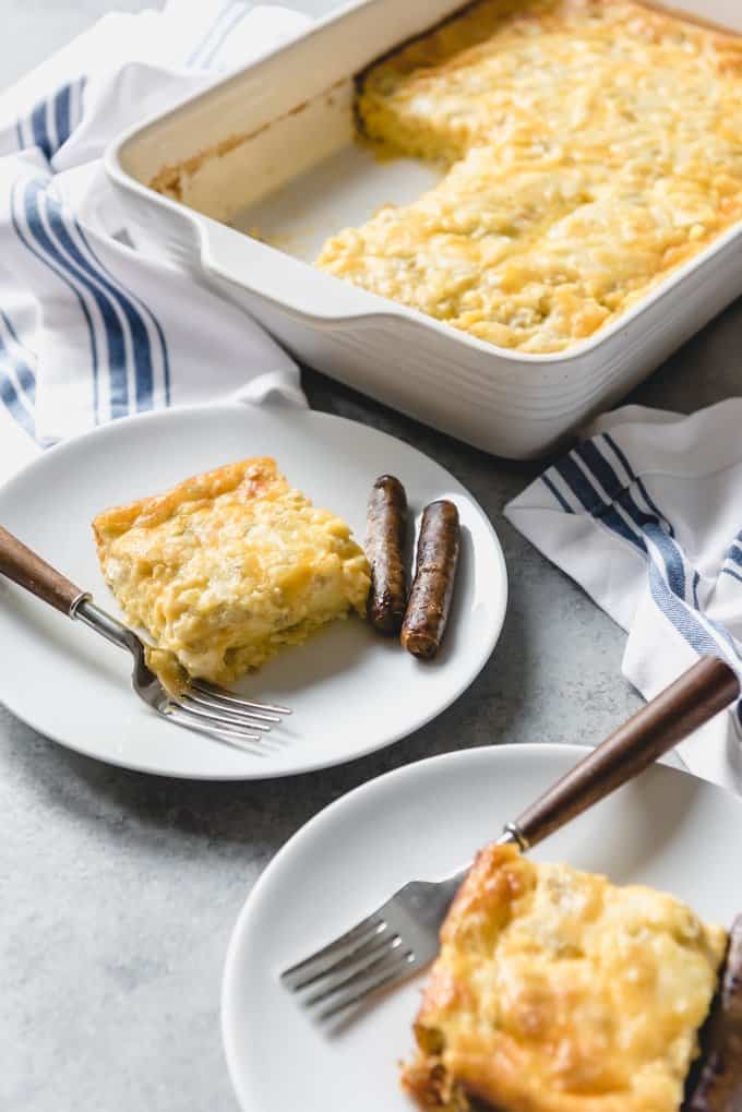 An image of a sliced cheesy make ahead breakfast casserole with sausage on the plate beside it.