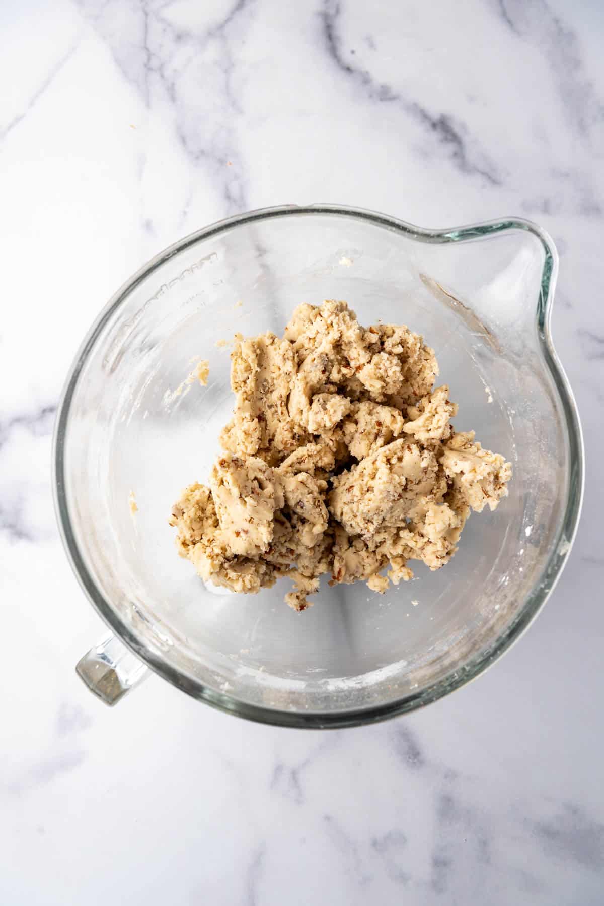 An overhead image of Mexican wedding cookie dough in a mixing bowl.