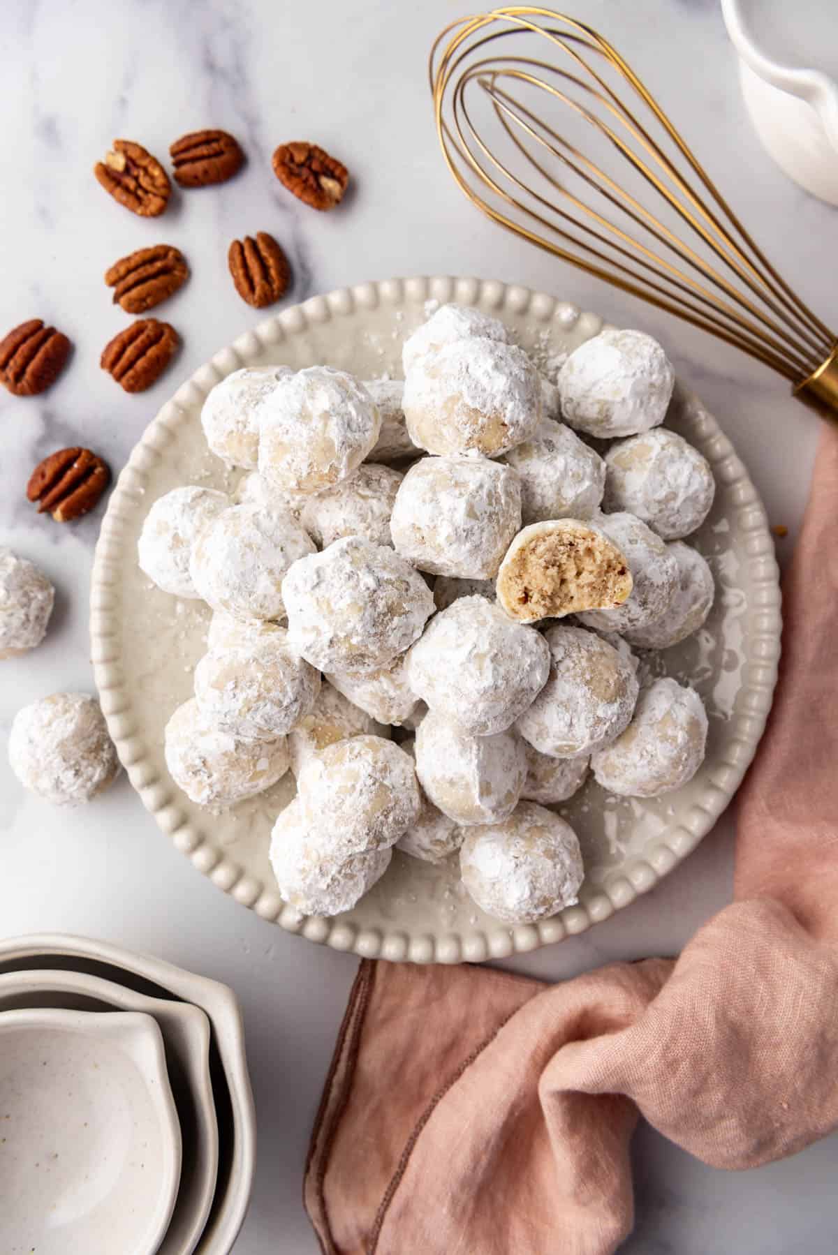 An overhead image of a plate of Mexican wedding cookies.