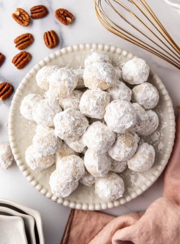 An overhead image of a plate of Mexican wedding cookies.