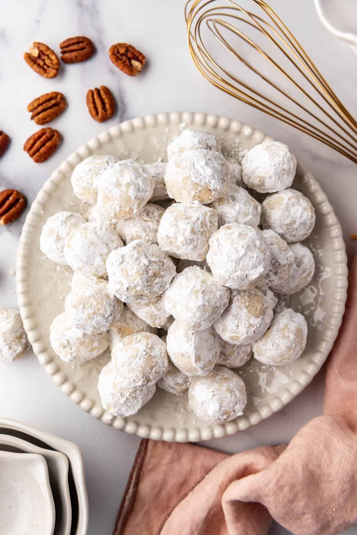 An overhead image of a plate of Mexican wedding cookies.