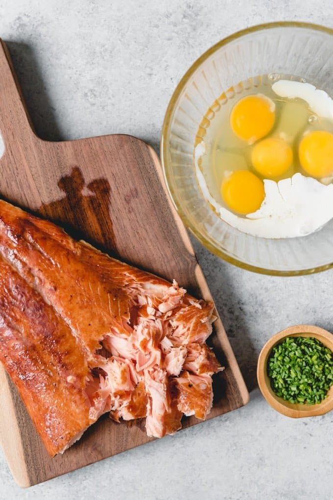 An image of smoked salmon with eggs, milk, and chives for making smoked salmon scrambled eggs.