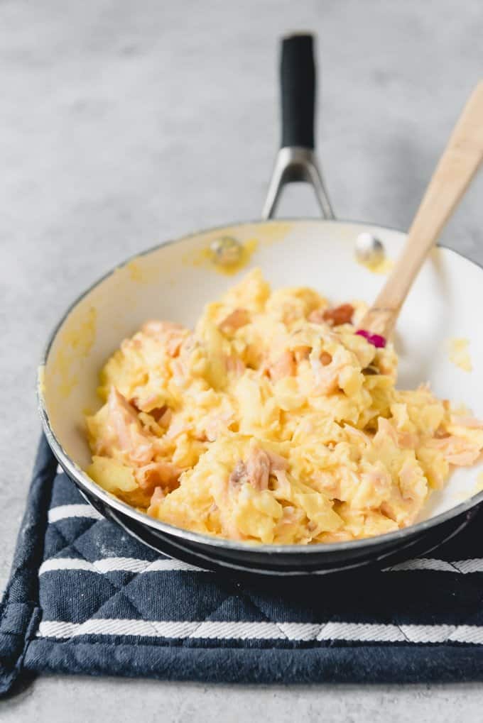 An image of a pan of soft scrambled eggs with salmon.