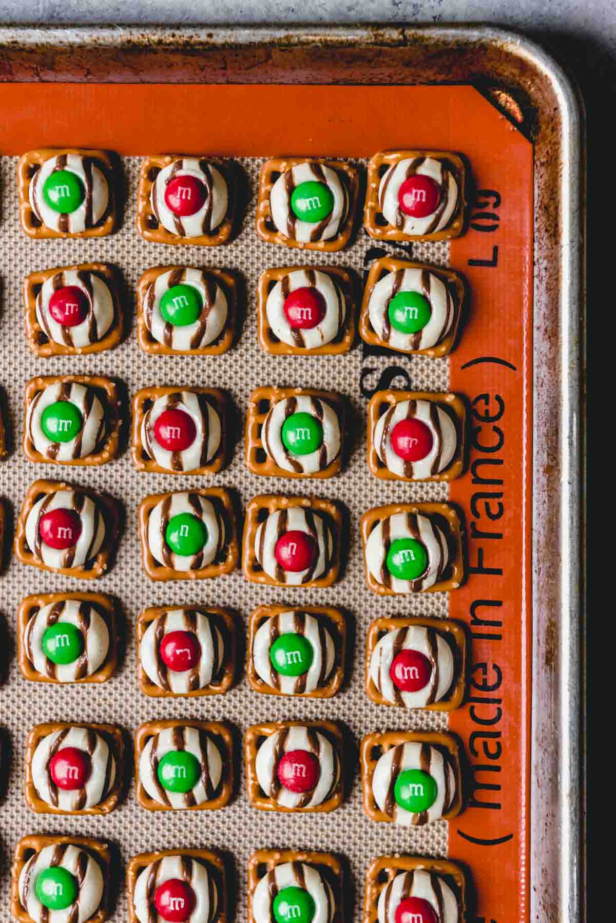 Prepared Christmas hugs on a silicone lined baking sheet.