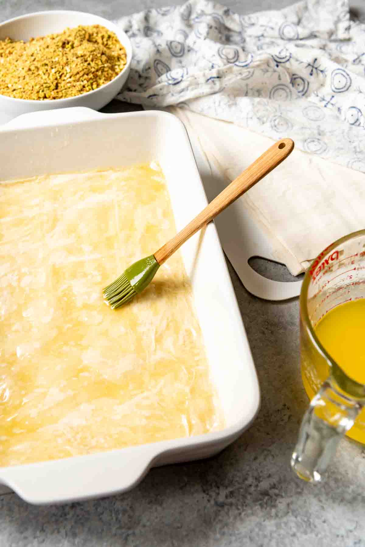 Brushing phyllo dough with melted butter.