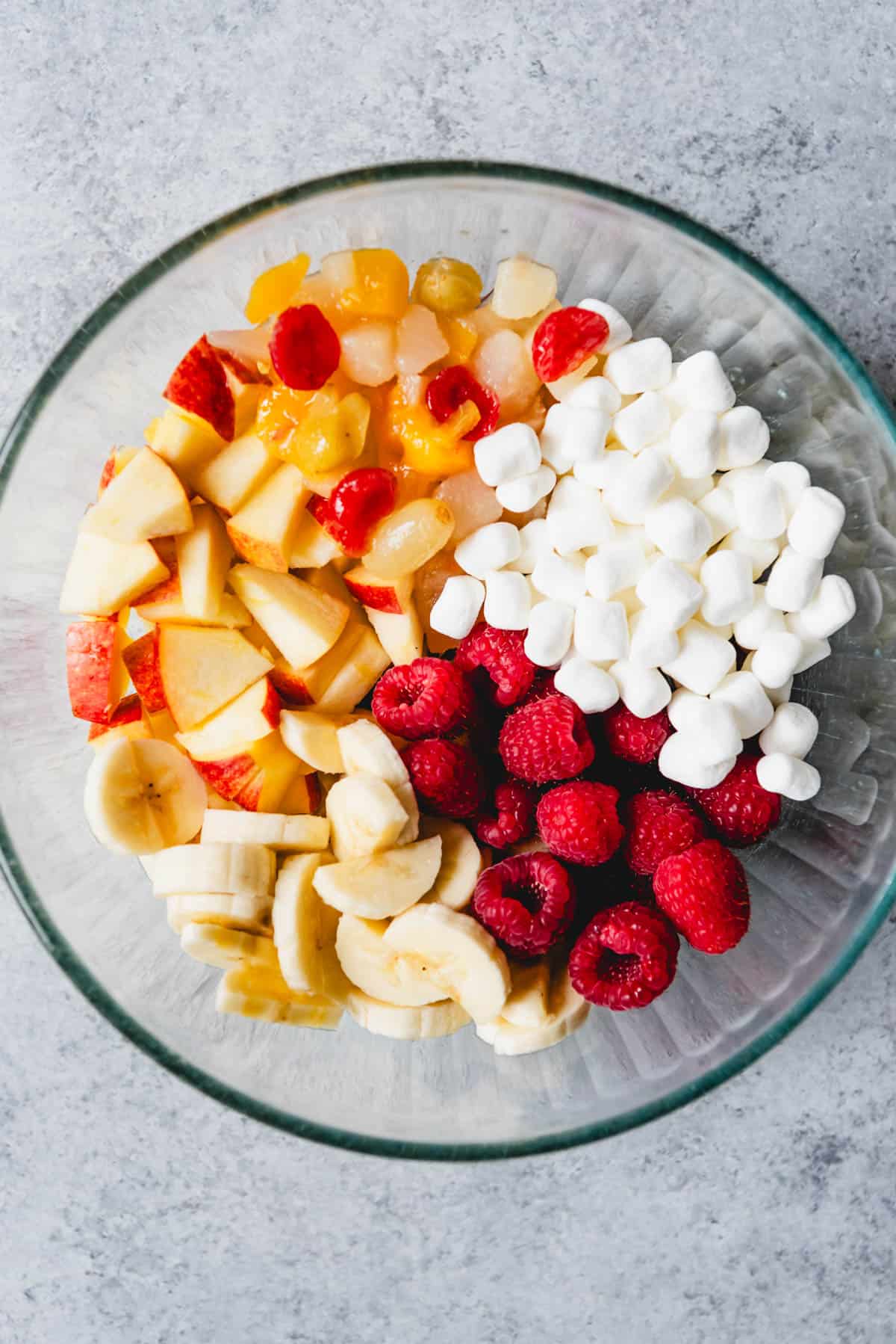 An image of a bowl of chopped fruit with marshmallows for making a fresh fruit salad.