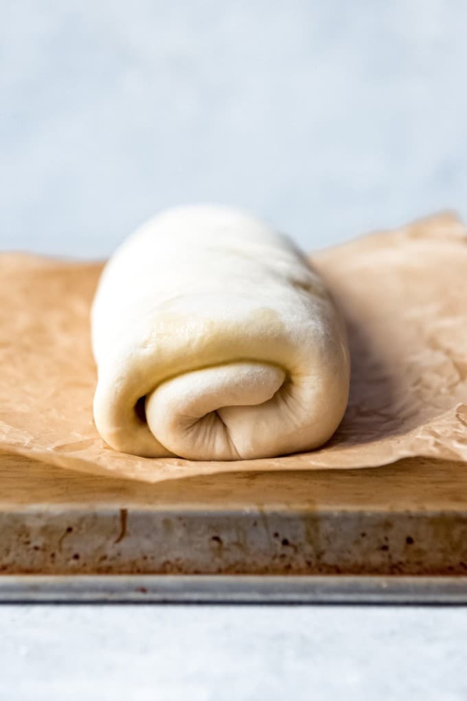a rolled log of dough on parchment paper