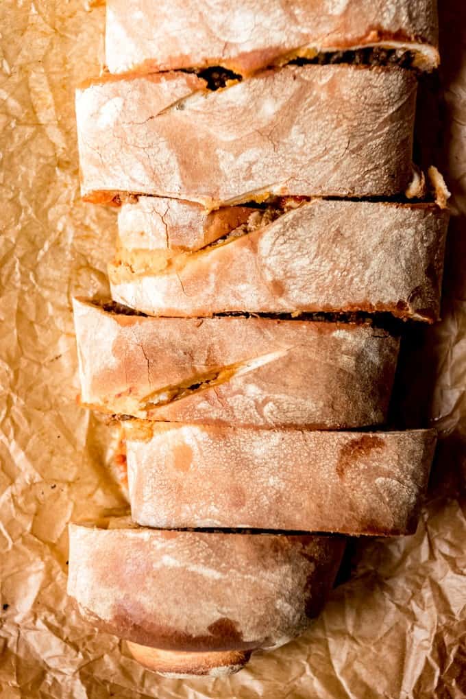 An image of a homemade stromboli cut into slices for a delicious game day appetizer.
