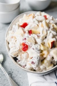 a bowl of fruit salad with whipped cream