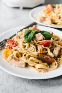 One Pot Bruschetta Chicken Pasta is a full-flavored pasta dish made with tender chicken, garlic, fresh basil, and bright cherry tomatoes.  It's an easy weeknight meal made entirely in one pot with all the flavors of my favorite bruschetta (pronounced “broo-sketta”, not “broo-schetta”).