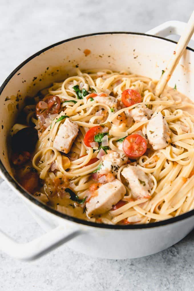 An image of a pot full of pasta for an quick weeknight dinner that takes less than 30 minutes of bruschetta chicken pasta.