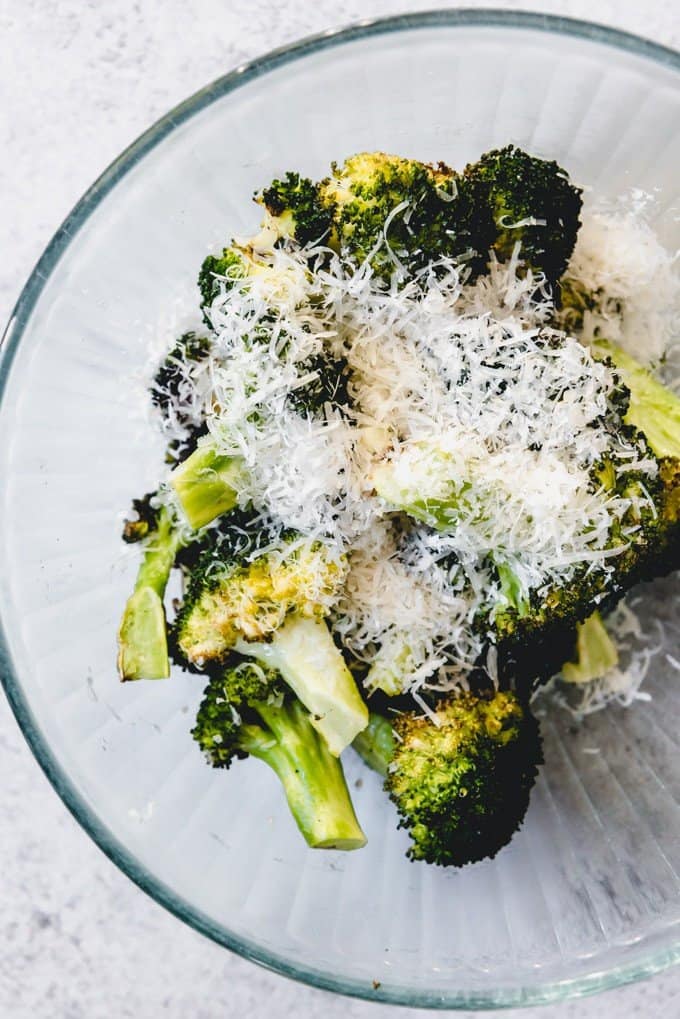 An image of a bowl of roasted broccoli with Parmesan cheese sprinkled on top.