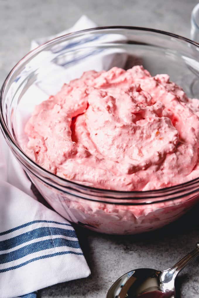An image of a bowl of fluffy pink cottage cheese jello salad.