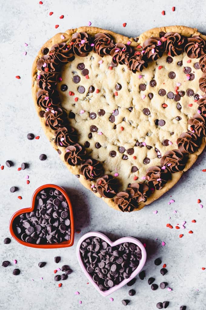 An image of a heart-shaped chocolate chip cookie for Valentine's Day.