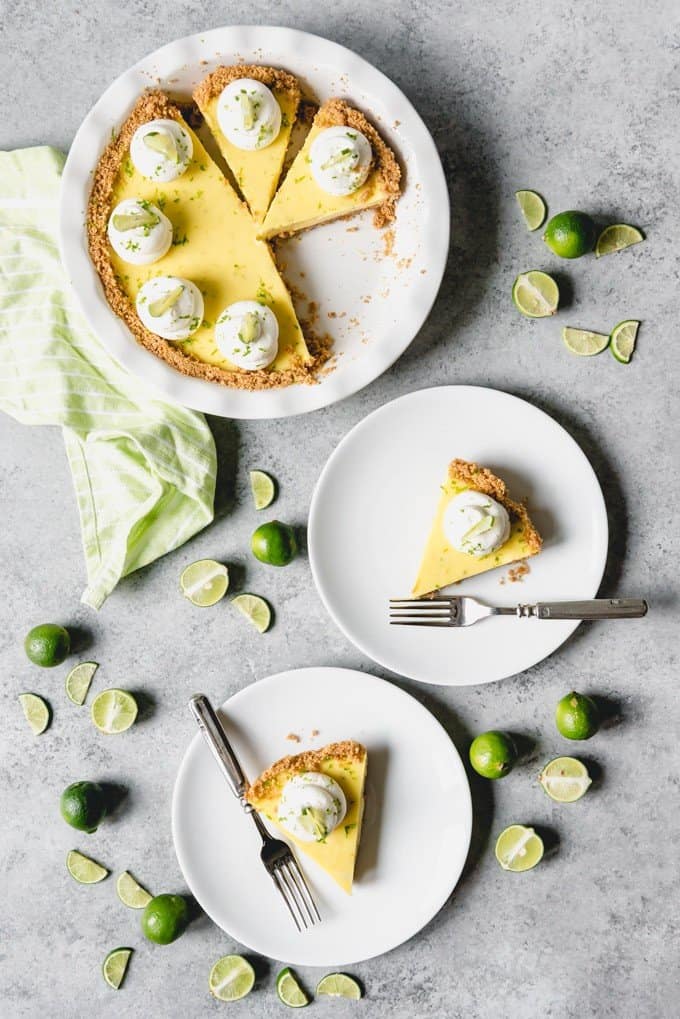 An image of slices of easy key lime pie made from scratch and served on white plates.