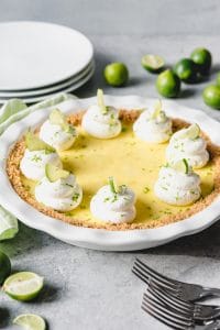 a key lime pie garnishes with keylime slices and whipped cream