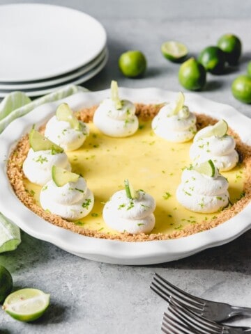 a key lime pie garnishes with keylime slices and whipped cream
