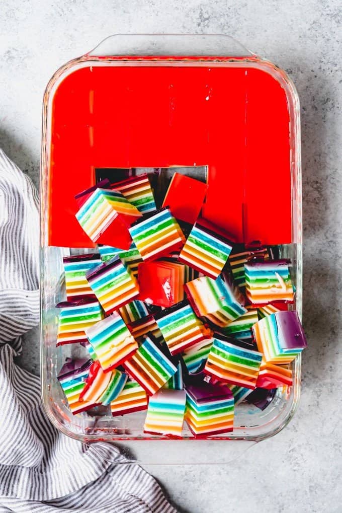 An image of a pan full of finger food size rainbow jello cubes.