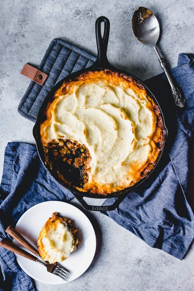 An image of classic shepherd's pie, a traditional Irish recipe, made with ground lamb, vegetables, a rich gravy, and creamy mashed potatoes on top.