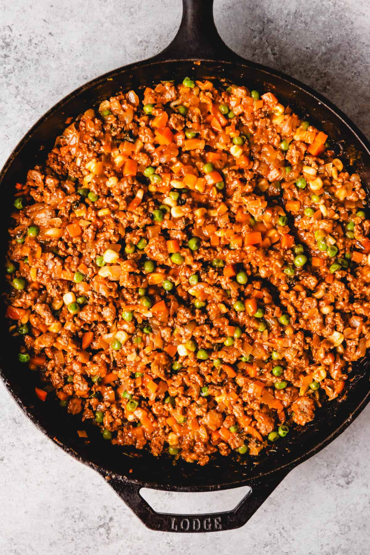 Shepherd's pie filling in a large cast iron skillet.