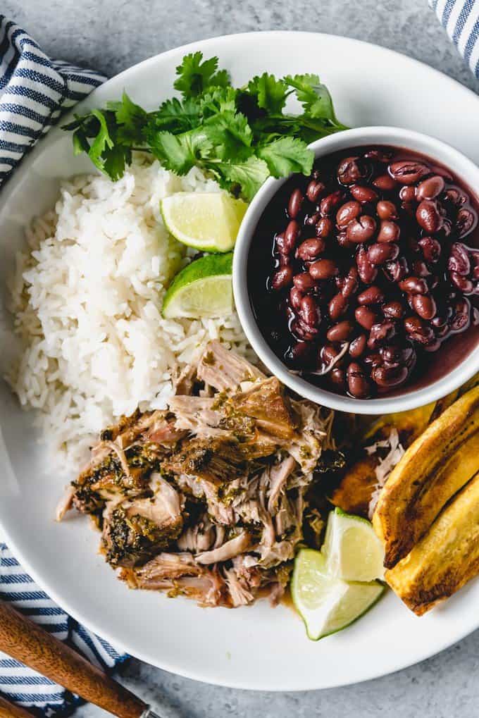 An image of a place of rice, beans, fried plantains, and Cuban pulled pork.