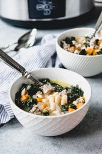 two bowls of soup in front of a slow cooker