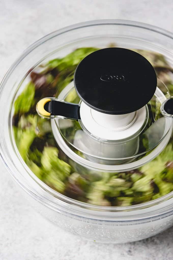 An image of freshly chopped and washed lettuce being spun in a salad spinner to make it crunchy, crispy and dry.