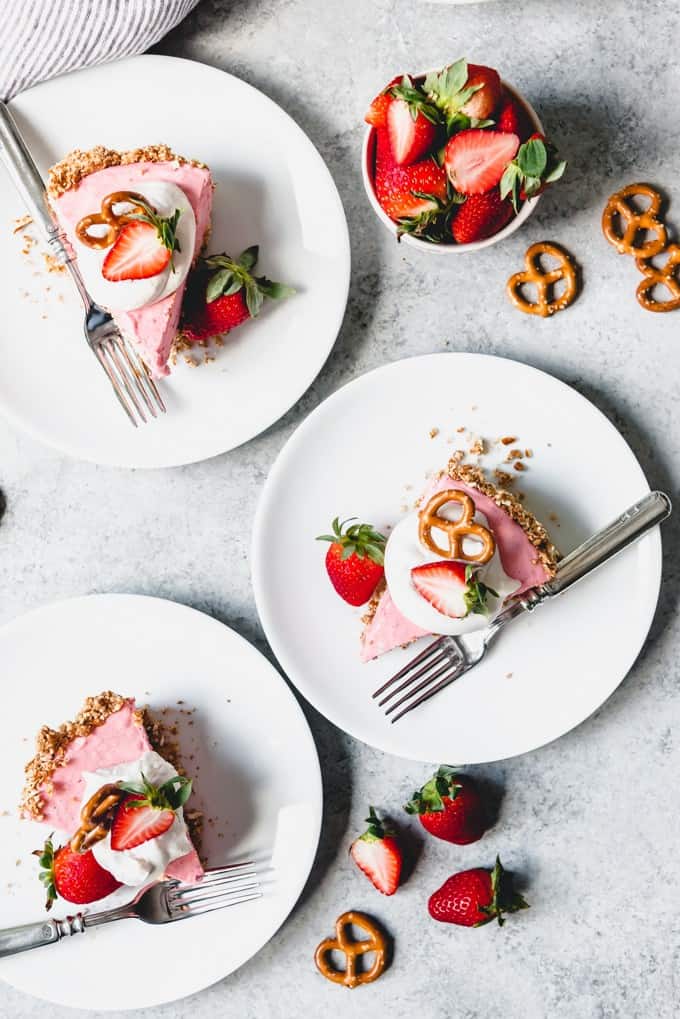 An image of slices of strawberry pretzel icebox pie on plates.