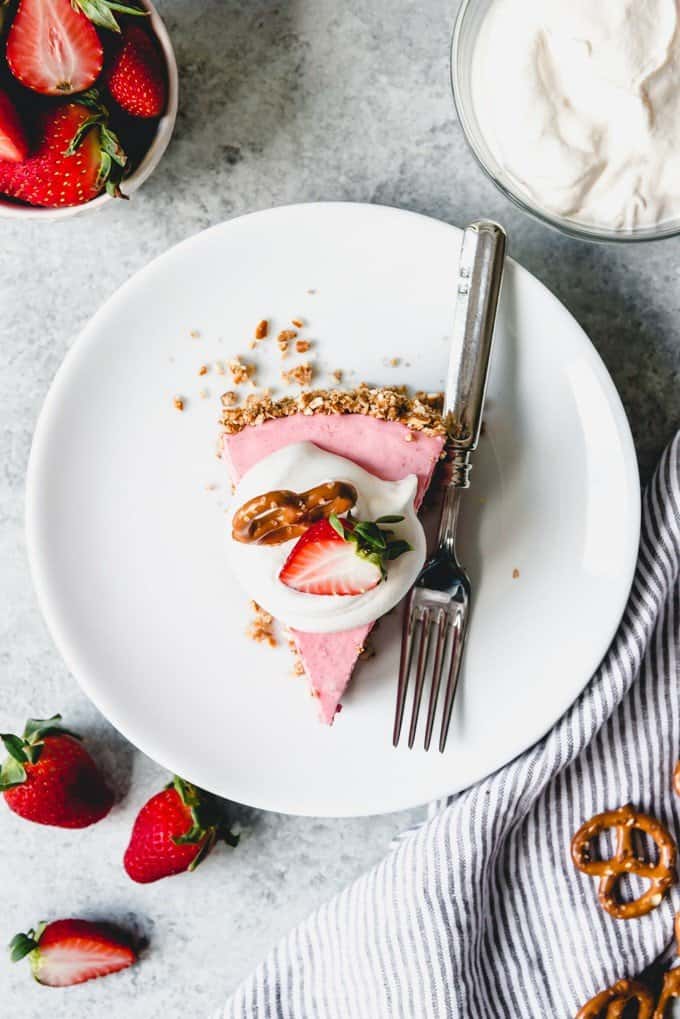 An image of a slice of strawberry pretzel pie on a white plate.