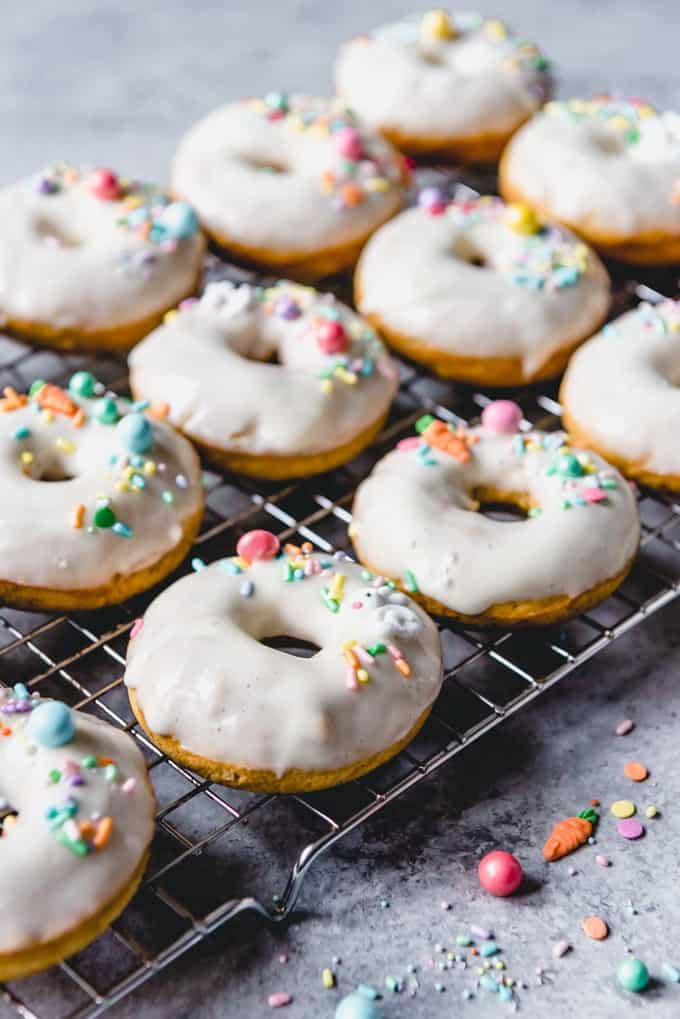 An image of homemade baked donuts with glaze and sprinkles on top.