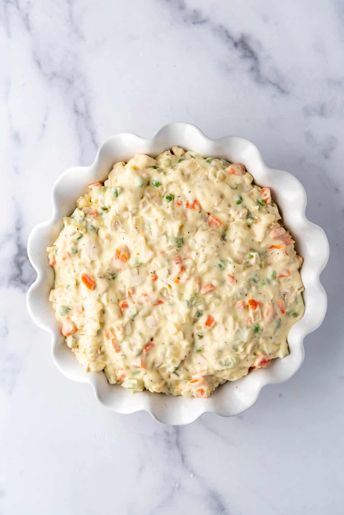 Pot pie filling in a pie plate with ruffled edges.