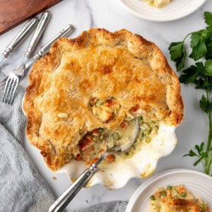 An overhead image of a chicken pot pie with some servings removed from it.