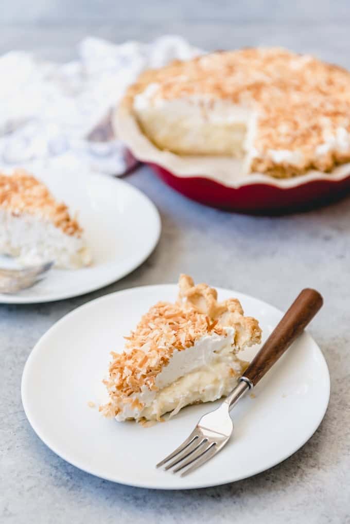 An image of a slice of the best coconut cream pie recipe on a white plate.